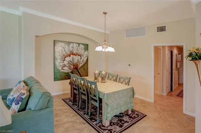 a living room with furniture a chandelier and a rug