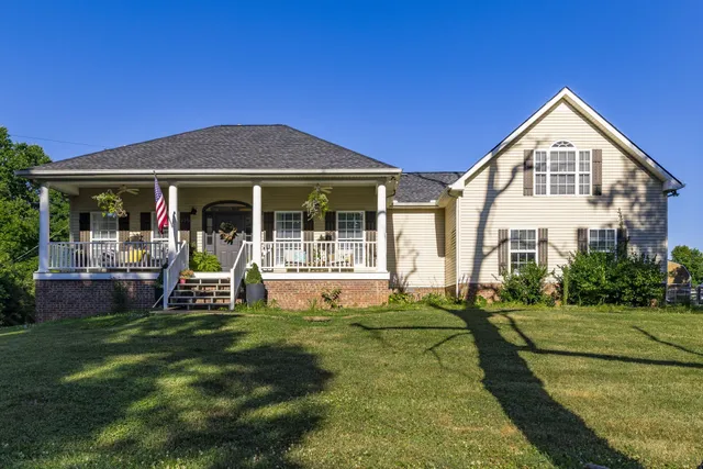 a view of a house with a yard porch and sitting area