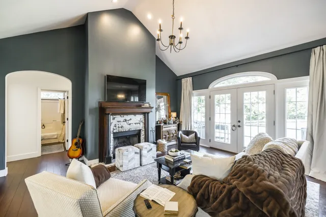 a living room with fireplace furniture and a flat screen tv