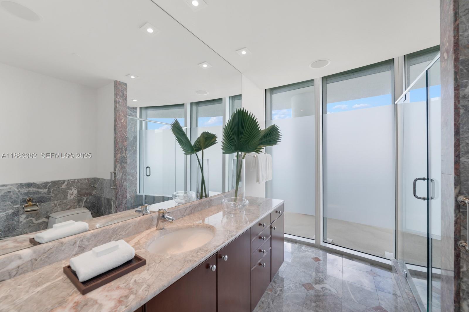 1643 Brickell Avenue, Unit PH4902 Miami, FL 33129 - Photo 18 of 38 a bathroom with a double vanity sink and mirror