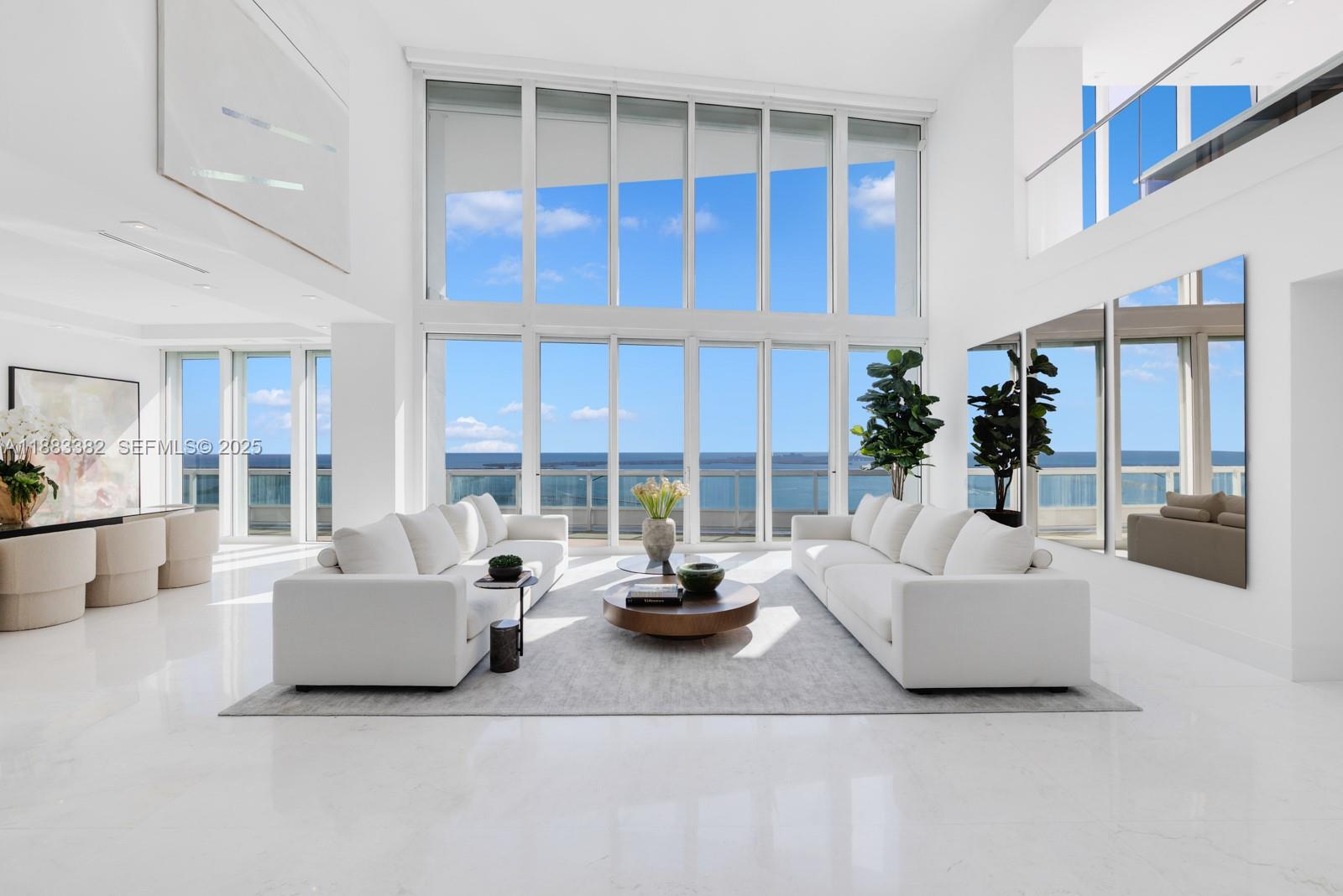 1643 Brickell Avenue, Unit PH4902 Miami, FL 33129 - Photo 2 of 38 a living room with furniture stairs and a table