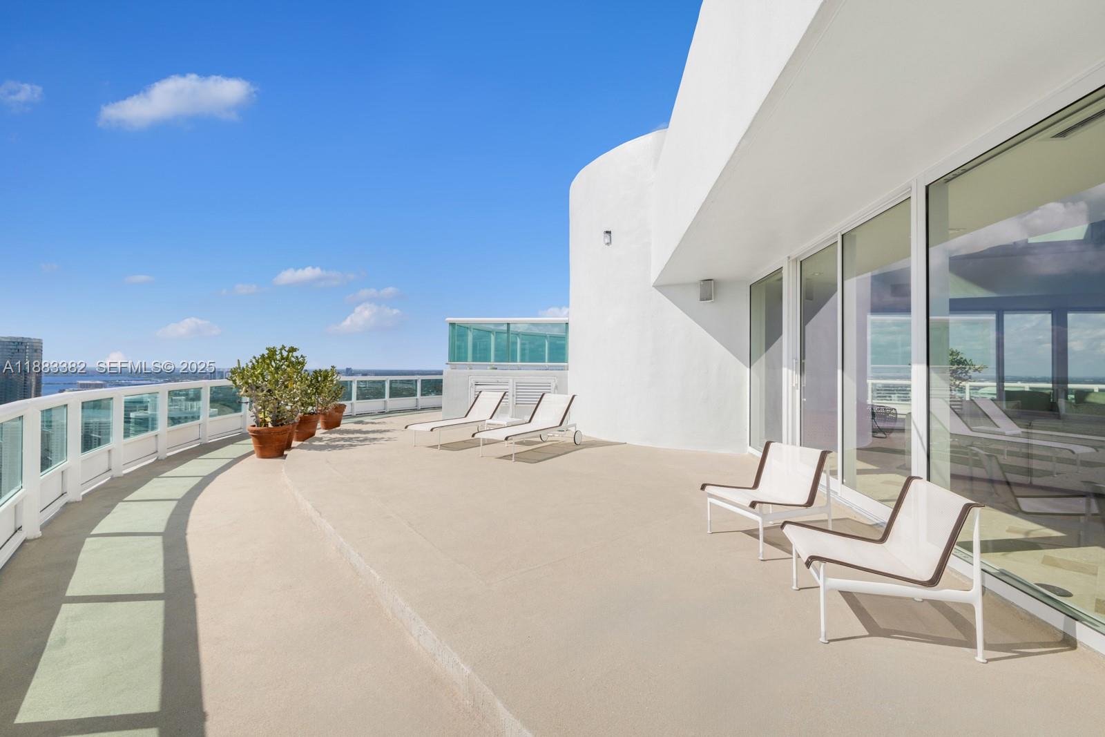 1643 Brickell Avenue, Unit PH4902 Miami, FL 33129 - Photo 24 of 38 a bedroom with a bed and a chandelier