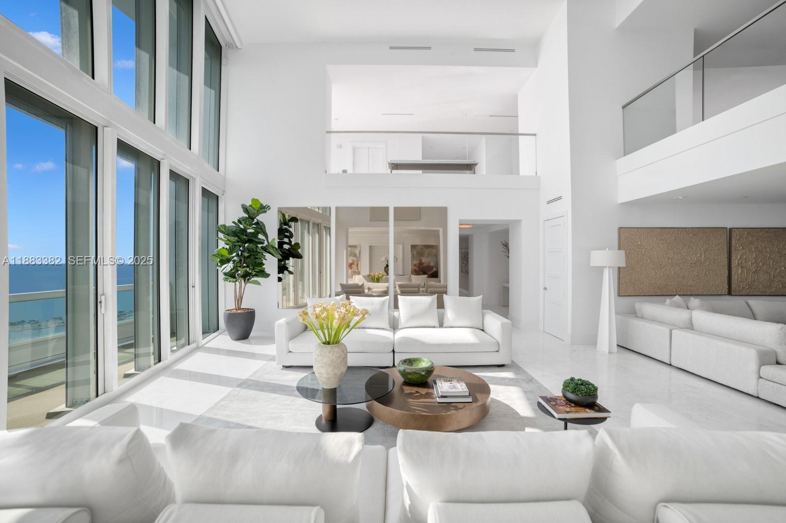 1643 Brickell Avenue, Unit PH4902 Miami, FL 33129 - Photo 3 of 38 a living room with furniture and a large window