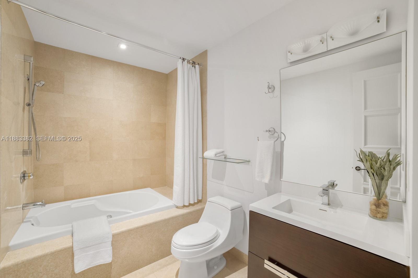 1643 Brickell Avenue, Unit PH4902 Miami, FL 33129 - Photo 31 of 38 a bathroom with a sink a toilet a tub and shower