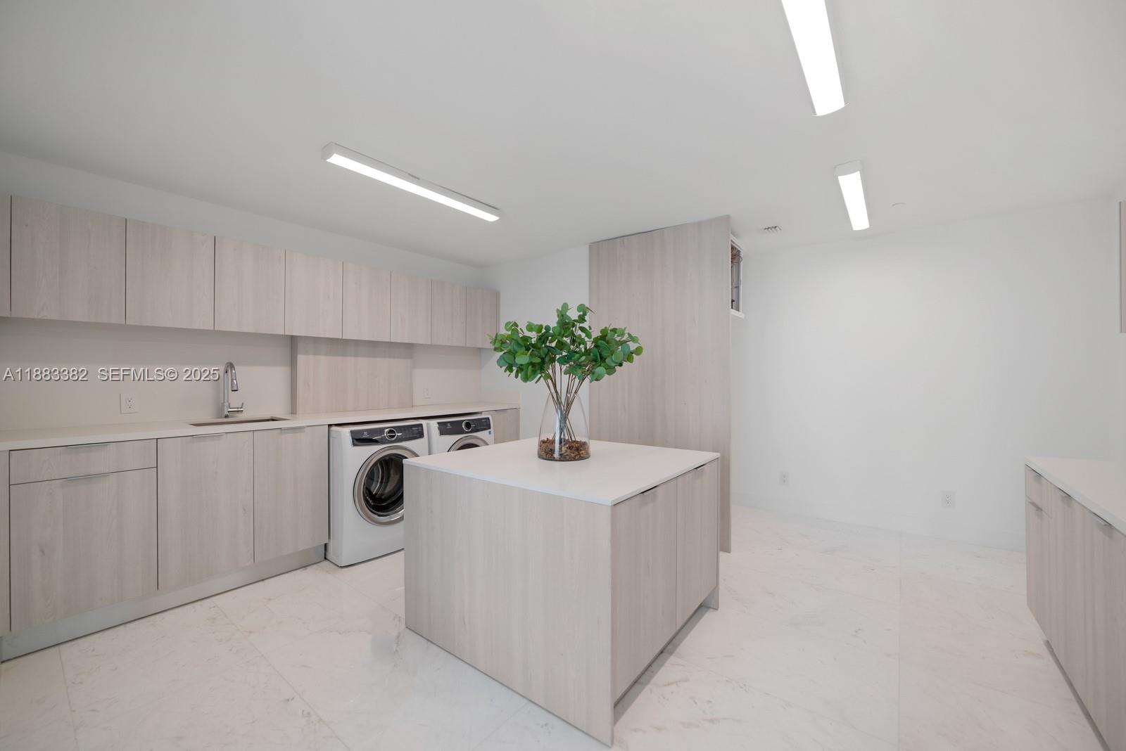 1643 Brickell Avenue, Unit PH4902 Miami, FL 33129 - Photo 33 of 38 a kitchen with a white sink cabinets and appliances