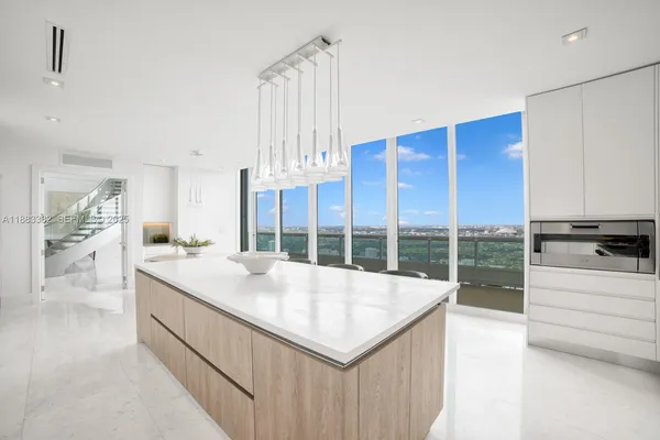 a kitchen with granite countertop a sink a stove and a wooden floors
