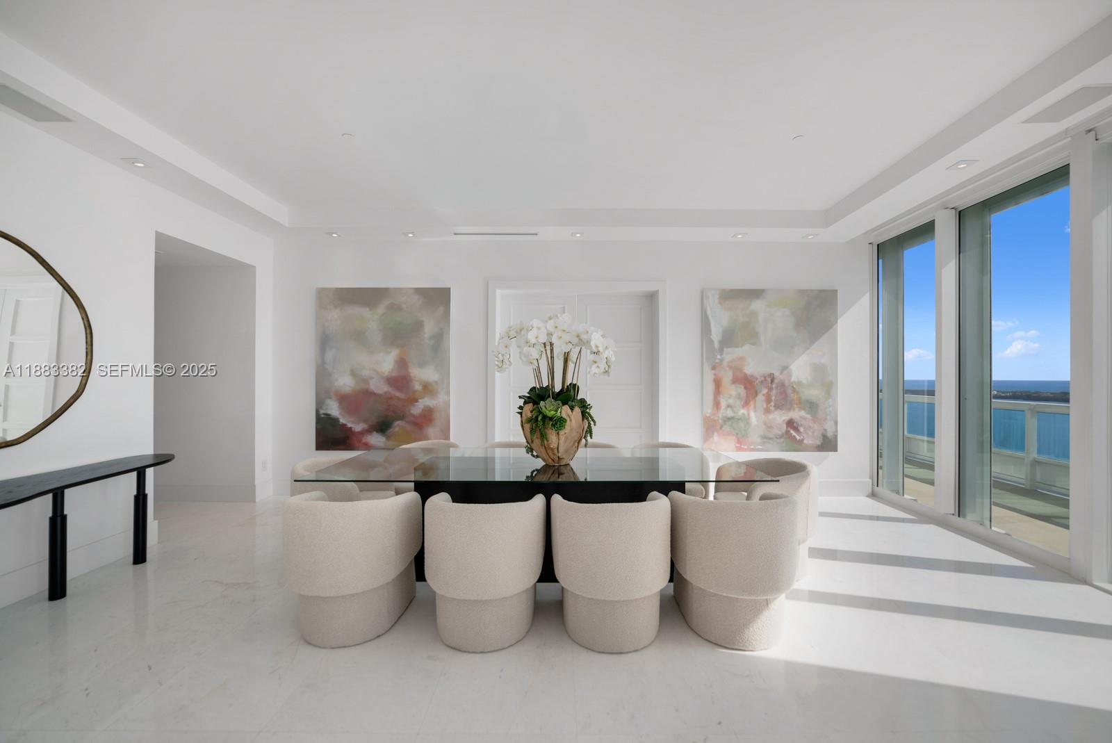 1643 Brickell Avenue, Unit PH4902 Miami, FL 33129 - Photo 10 of 38 a living room with furniture a lamp and a potted plant