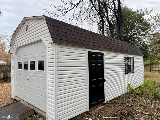 a view of a house with a yard and tree s