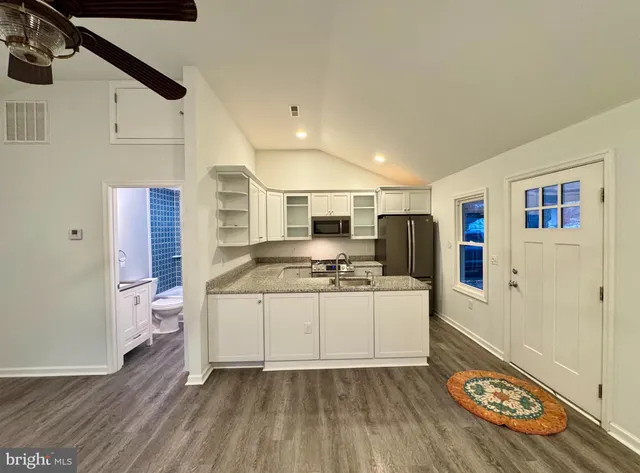 a kitchen with stainless steel appliances granite countertop a stove and a refrigerator