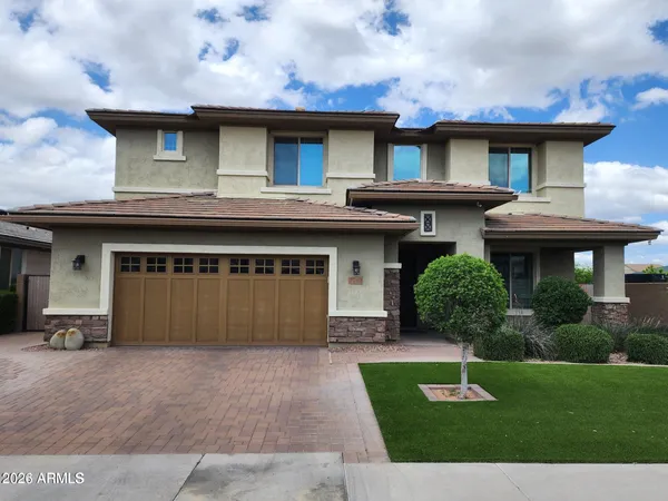 a front view of a house with a yard and garage