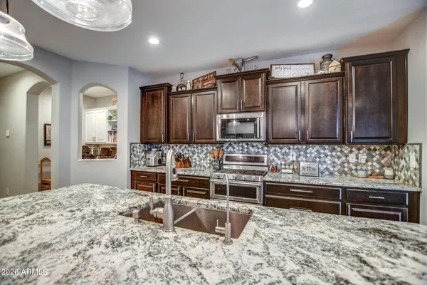 a kitchen with stainless steel appliances a sink and a microwave