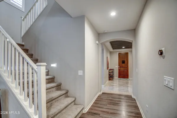 a view of a hallway with wooden floor and staircase