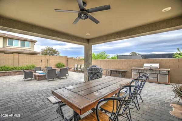 a view of a patio with table and chairs