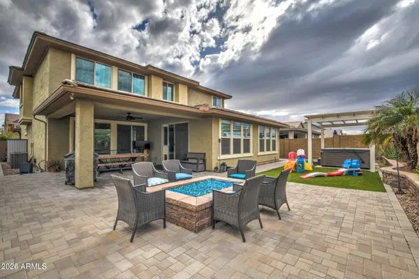 a view of a house with backyard porch and sitting area