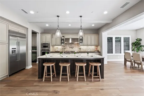 a large kitchen with a table and chairs