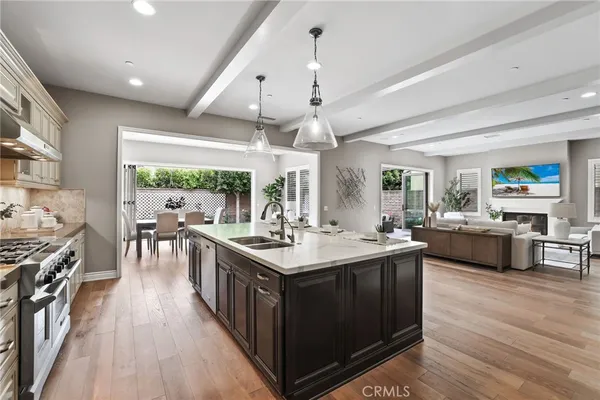 a kitchen with stainless steel appliances a refrigerator and a stove top oven