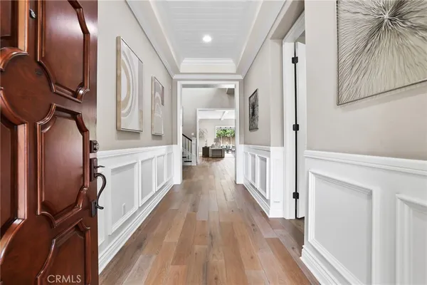 a view of a hallway with wooden floor and staircase