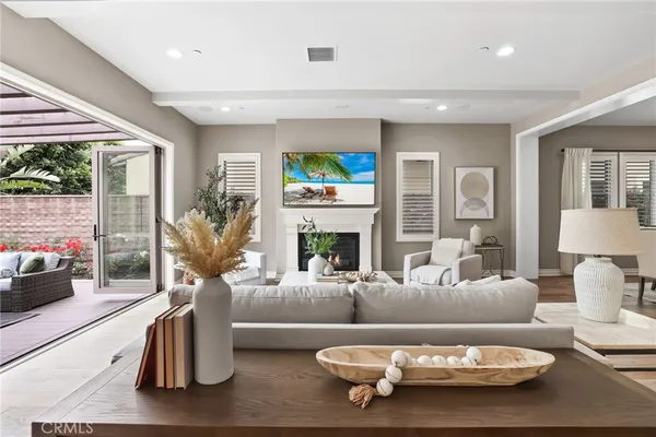 a living room with furniture a fireplace and a large window