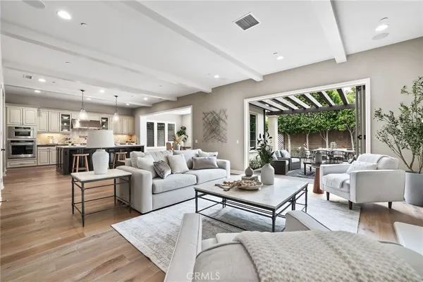 a living room with furniture wooden floor and a large window