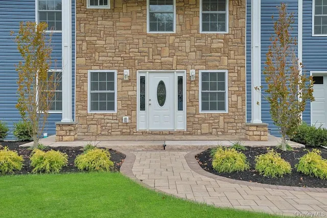 a front view of a house with garden
