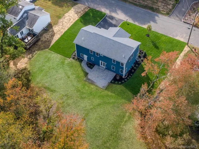 a view of house with backyard outdoor seating and entertaining space