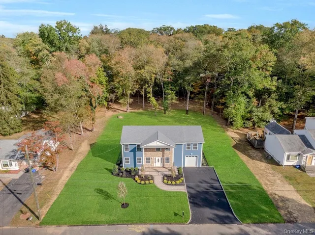an aerial view of a house with a yard