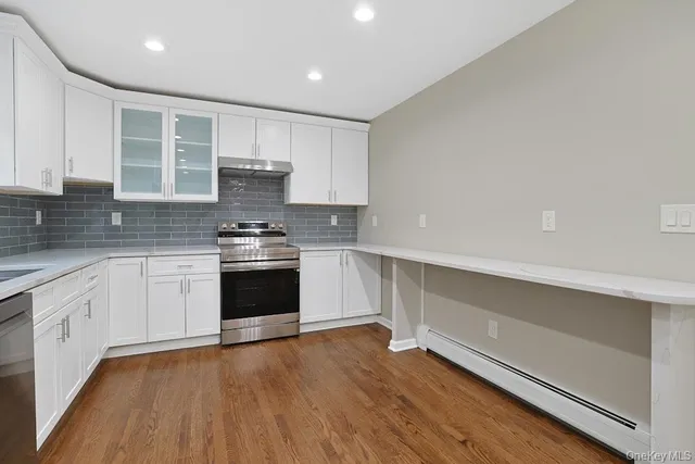 a view of a kitchen with a sink and a stove top oven