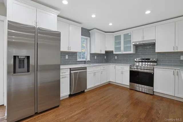 a kitchen with granite countertop a stove and a sink