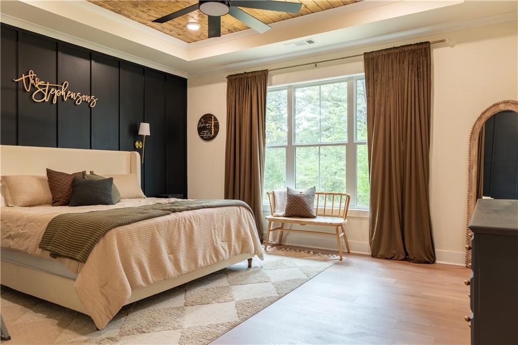 526 Brice Station Road Silver Creek, GA 30173 - Photo 13 of 32 a bedroom with a large bed and a chandelier