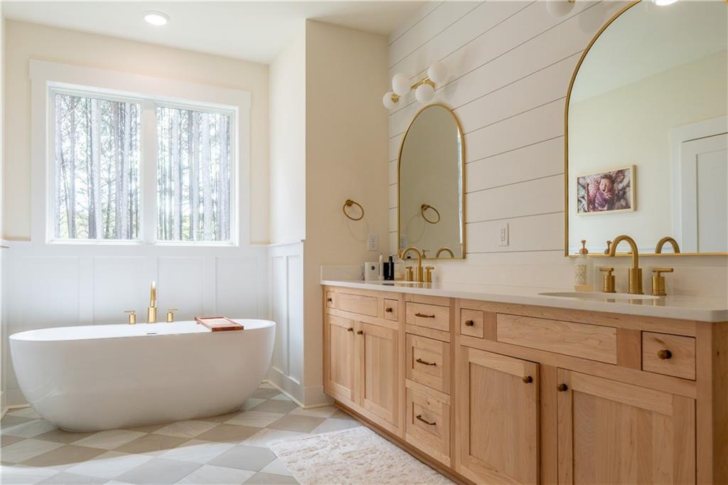 526 Brice Station Road Silver Creek, GA 30173 - Photo 15 of 32 a bathroom with a white tub a sink and mirror