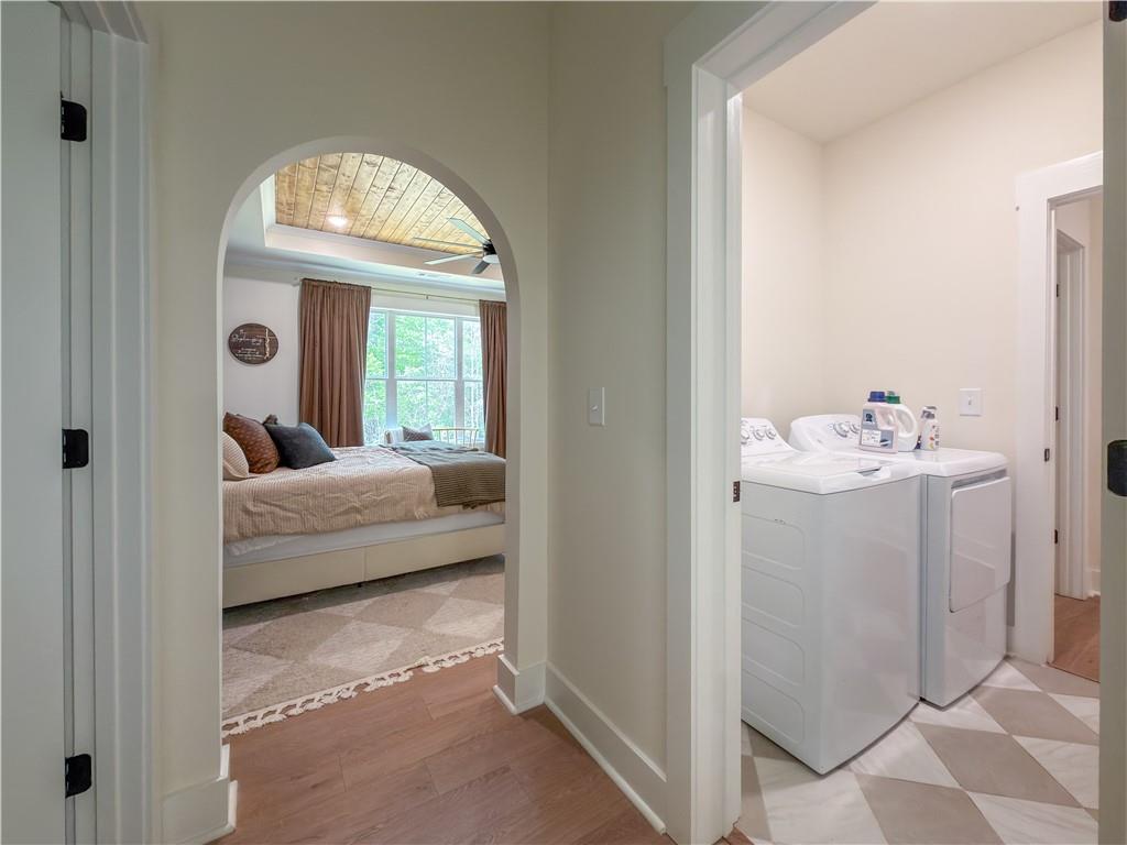 526 Brice Station Road Silver Creek, GA 30173 - Photo 19 of 32 a bedroom with a bed and a chandelier