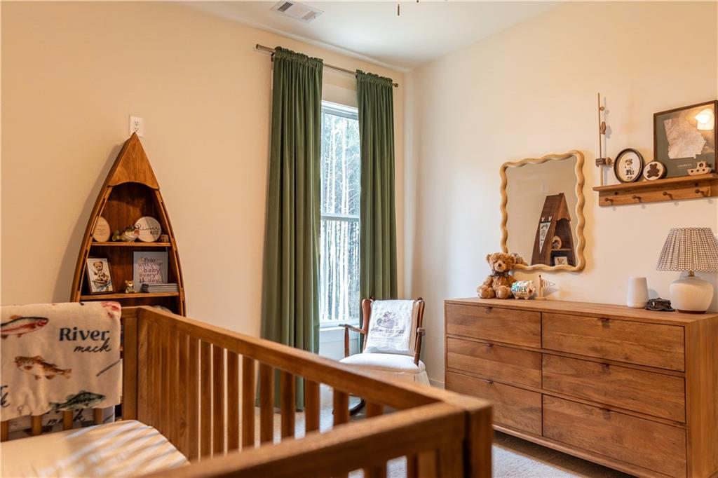526 Brice Station Road Silver Creek, GA 30173 - Photo 23 of 32 a view of a bedroom with baby crib and furniture