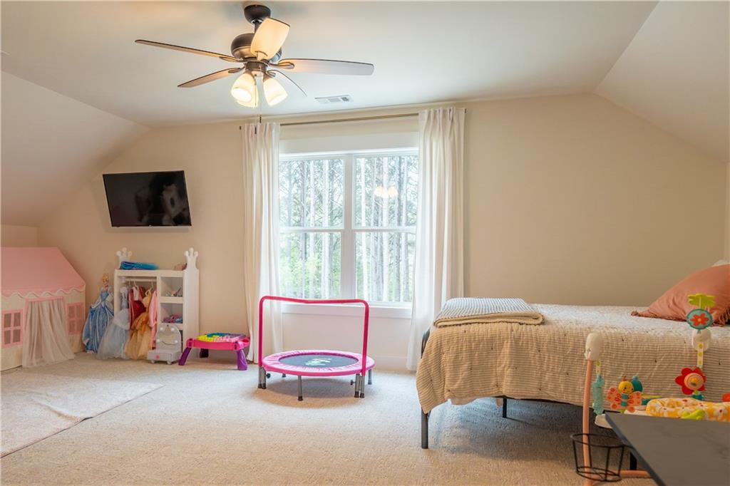 526 Brice Station Road Silver Creek, GA 30173 - Photo 25 of 32 a bedroom with furniture and a flat screen tv