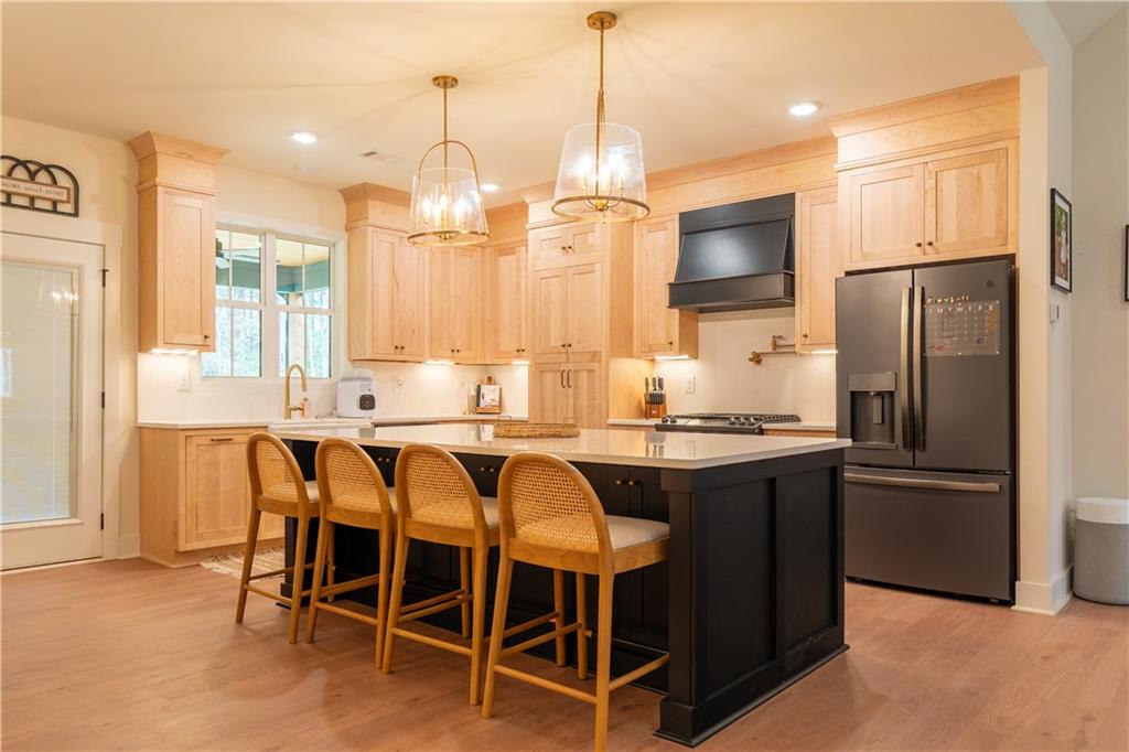 526 Brice Station Road Silver Creek, GA 30173 - Photo 7 of 32 a kitchen with granite countertop a sink appliances a counter space and a center island