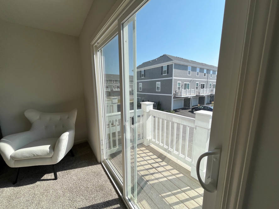 17325 Roscommon Road Tinley Park, IL 60477 - Photo 14 of 37 a view of a balcony with chair and wooden floor