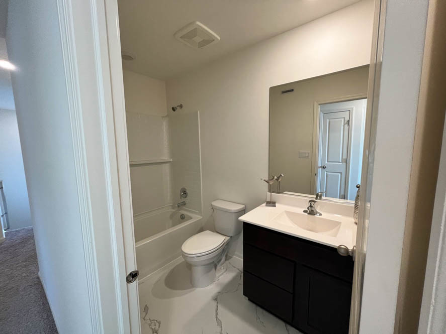 17325 Roscommon Road Tinley Park, IL 60477 - Photo 16 of 37 a bathroom with a sink a toilet and shower