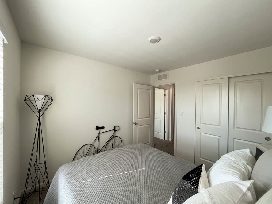 17325 Roscommon Road Tinley Park, IL 60477 - Photo 19 of 37 a bedroom with a bed and a chandelier