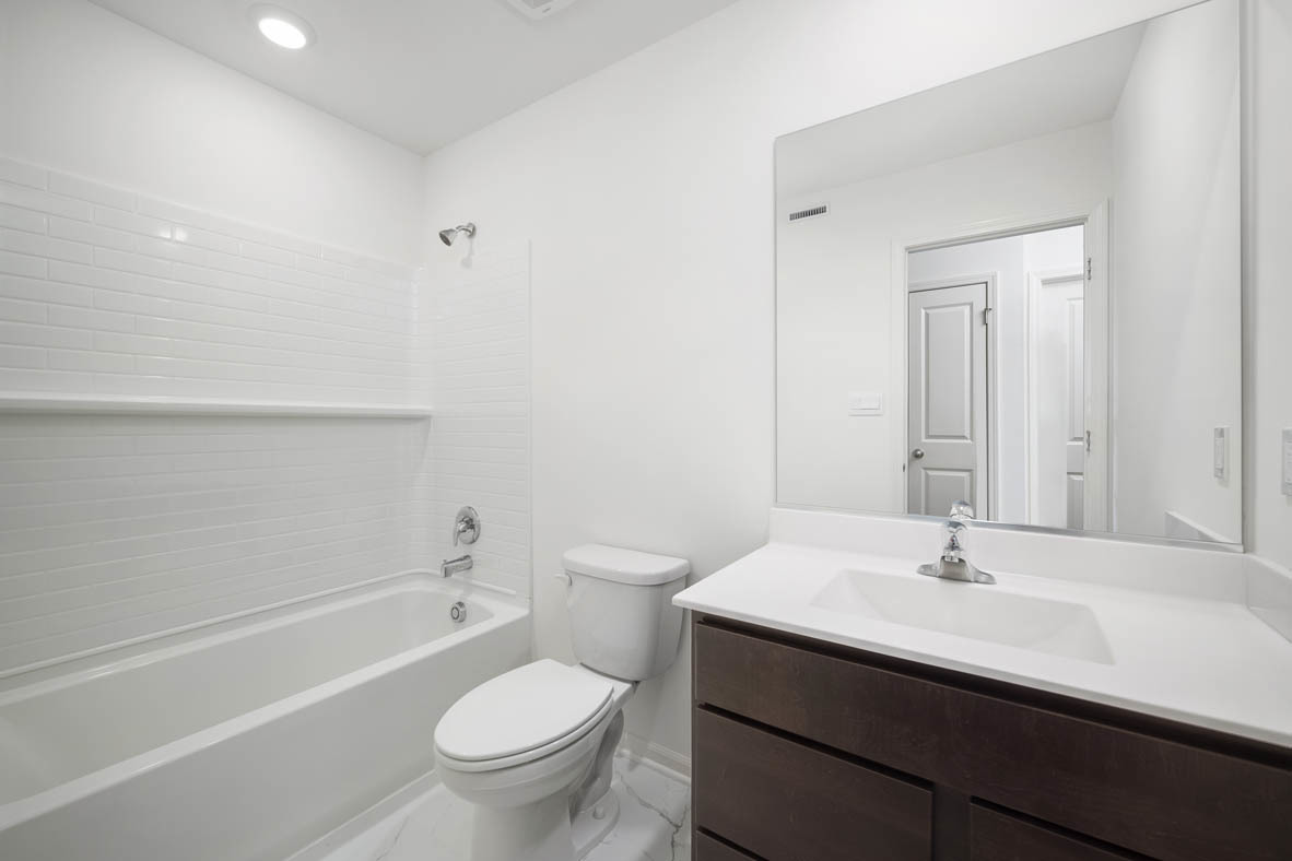 17325 Roscommon Road Tinley Park, IL 60477 - Photo 35 of 37 a bathroom with a sink a toilet and a mirror