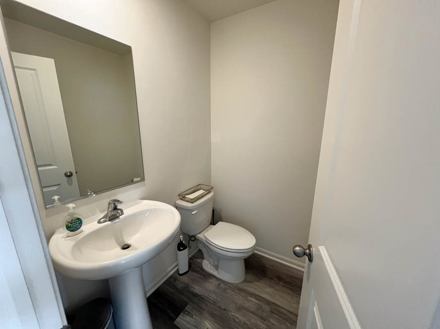 17325 Roscommon Road Tinley Park, IL 60477 - Photo 8 of 37 a bathroom with a sink toilet and a mirror