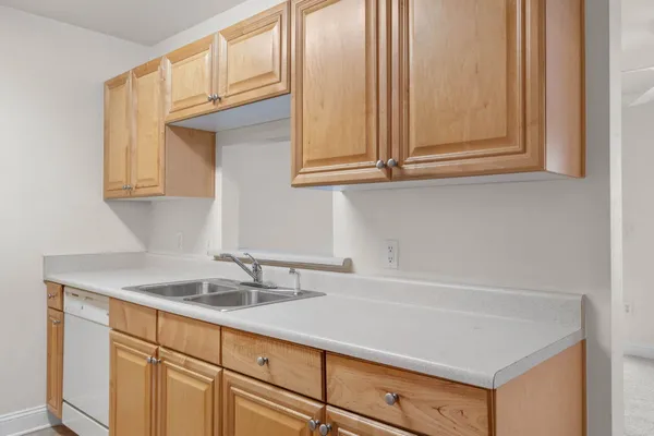 a kitchen with granite countertop white cabinets and a sink