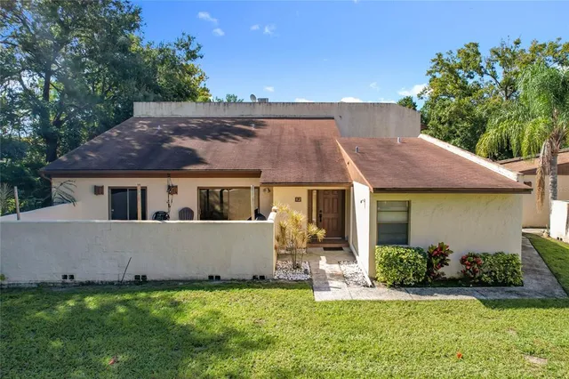 a front view of house with a garden