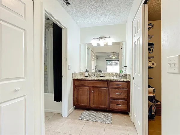 a bathroom with a granite countertop sink a mirror and a