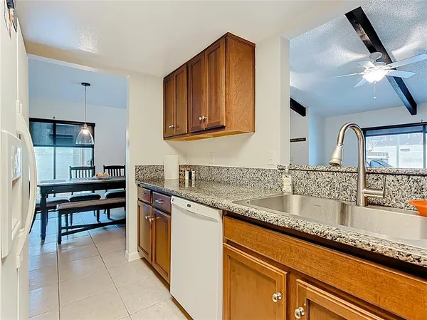 a kitchen with stainless steel appliances granite countertop a sink and a stove