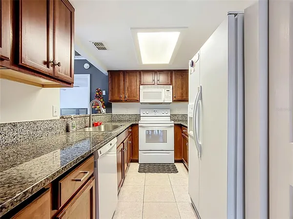a kitchen with stainless steel appliances granite countertop a sink and cabinets