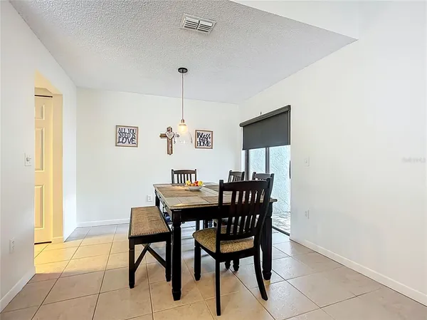 a view of a dining room with furniture and a window