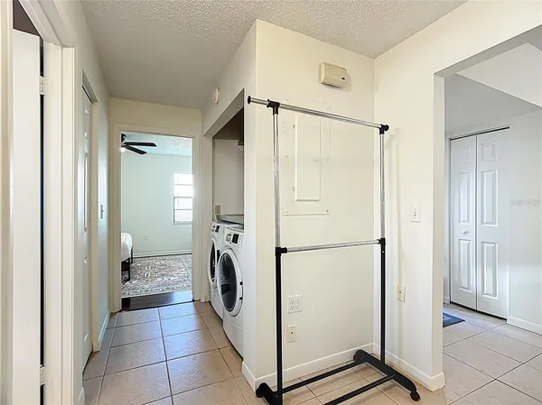 a view of a storage & utility room with closet dryer
