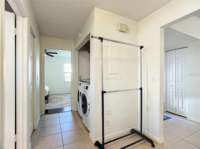 a view of a storage & utility room with closet dryer