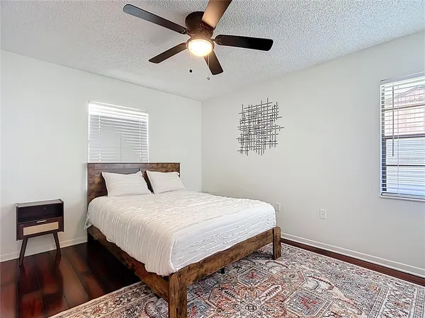 a bed sitting in a bedroom next to a window