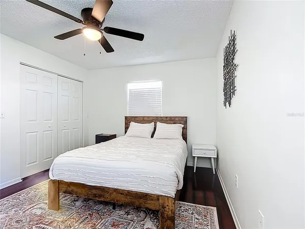 a bedroom with a bed and wooden floor