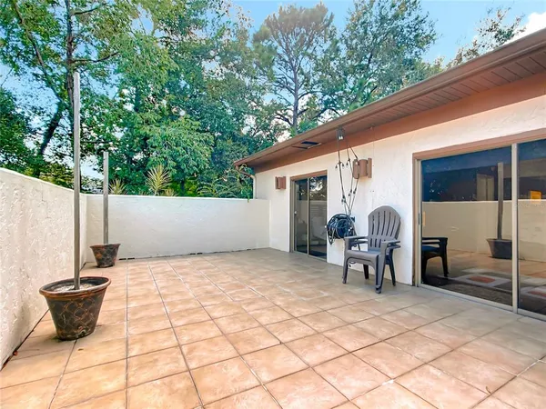 a backyard of a house with table and chairs